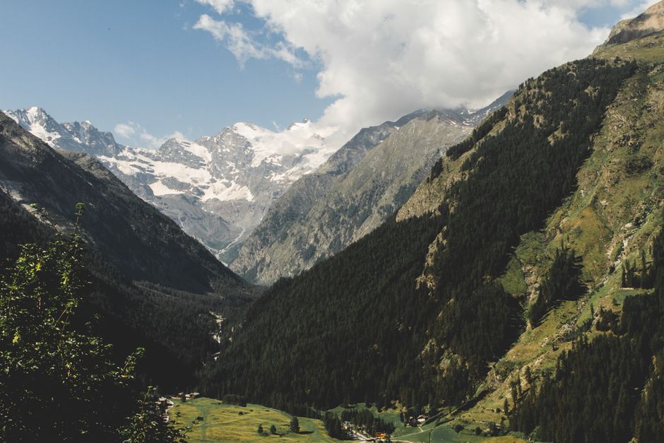 Breathtaking view of the Valsavarenche valley with majestic mountains and lush green forests.